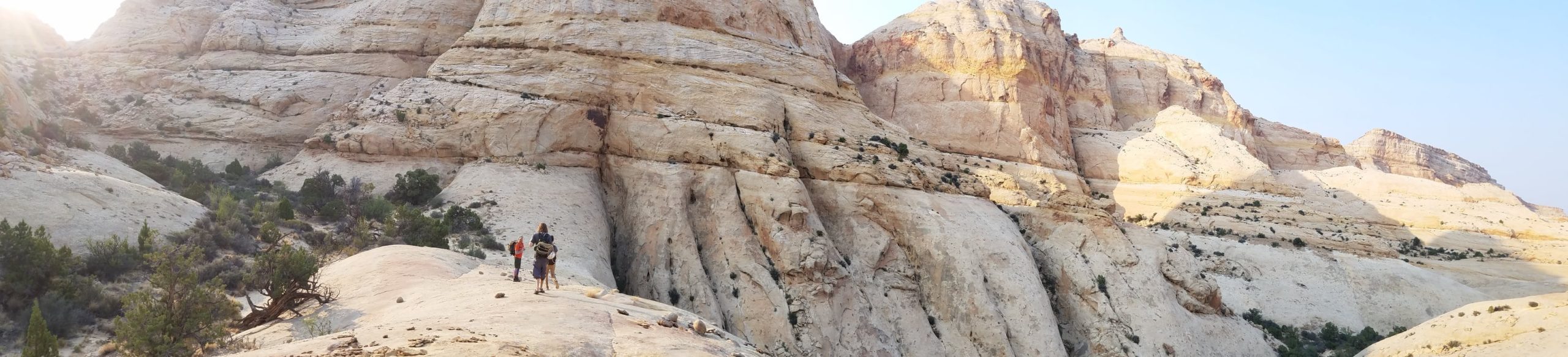 Hikers overlooking a Navajo Sandstone canyon in Capitol Reef Nation Park