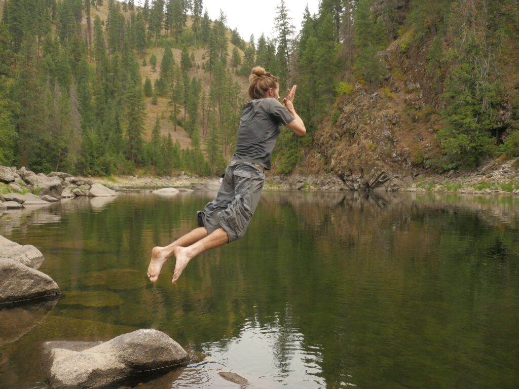 Bret jumping into a river